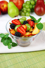 fresh tasty fruit salad on table