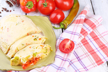 Casserole with vegetables on plate on table close-up