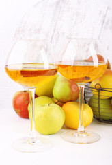 still life with apple cider and fresh apples on wooden table