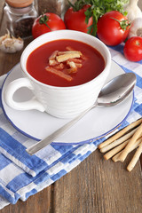 Tasty tomato soup with croutons on wooden table