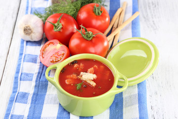 Tasty tomato soup with croutons on table close-up