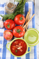 Tasty tomato soup with croutons on table close-up