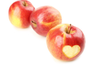 Red apple with heart isolated on white