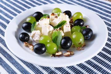 tasty salad with grape and cheese, close up