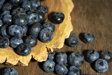Tasty ripe blueberries, on wooden background