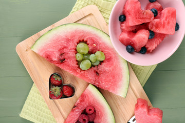 Fresh juicy watermelon slice  with cut out heart shape, filled