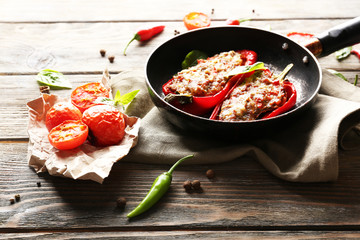 Delicious stuffed peppers in frying pan on table close-up