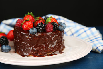 Tasty chocolate cake with different berries