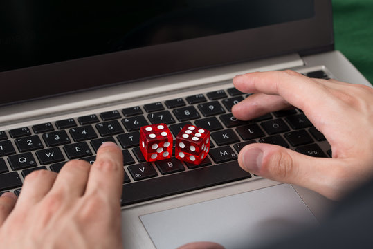 Red Game Dices On Laptop