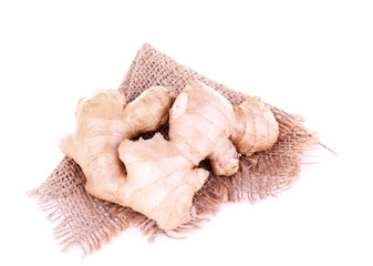 Ginger root on sackcloth napkin isolated on white