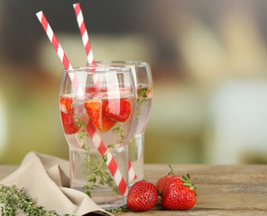 Tasty cool beverage with strawberries and thyme,
