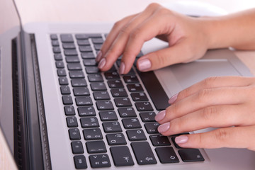 Female hands working on laptop close up