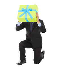 Businessman holding a gift box and kneel down .