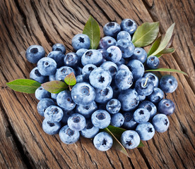 Blueberries over old wooden table.