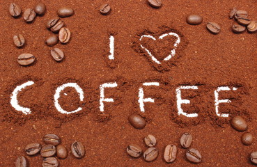 Coffee word written on ground coffee and grains