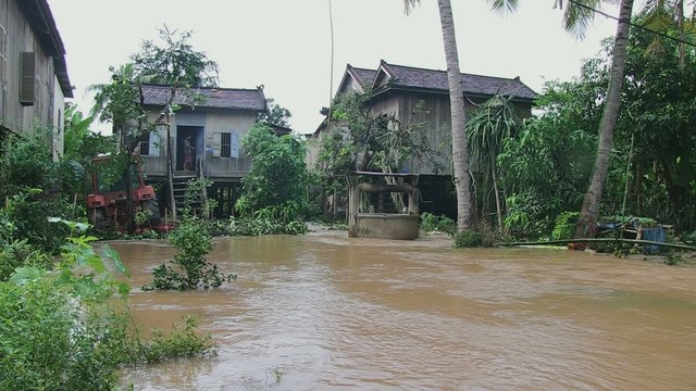 Flood waters under stilt-houses during the torrential monsoon rains