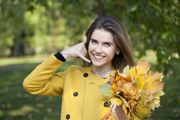 Beautiful woman making a call me gesture