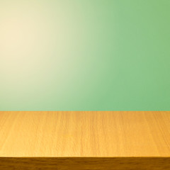 Empty wooden modern table over green solid color background