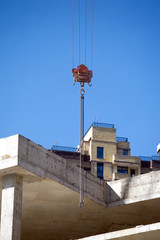 Fototapeta na wymiar Hoisting tower crane screw and top of construction building