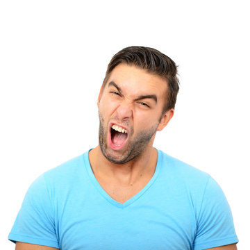 Portrait of angry man screaming against white background