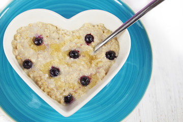 Blueberry Porridge or Oatmeal in a heart shaped bowl.