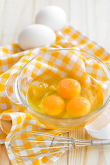 Raw eggs and whisk