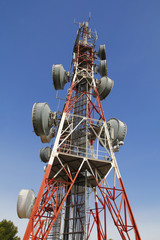 Telecommunications tower against blue sky