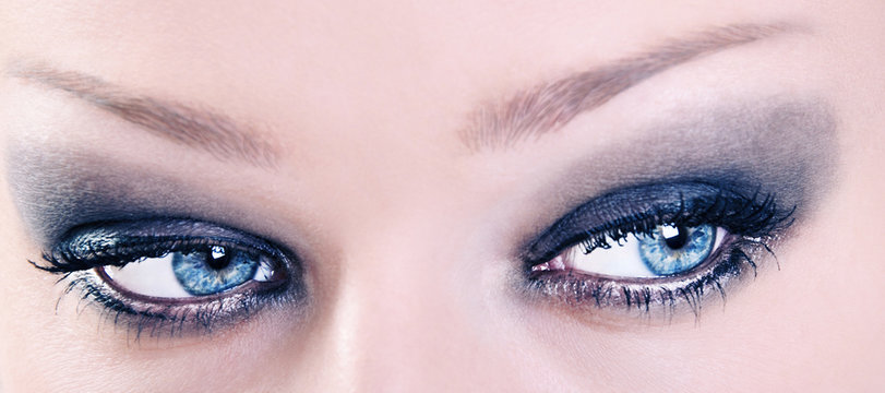 Close Up of Adorable Female Blue Eyes with Black Make Up
