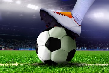Feet on Soccer Ball in the Stadium