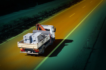 The truck with bricks on a highway.