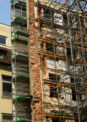 Reconstruction of old building with scaffolding undergoing repai