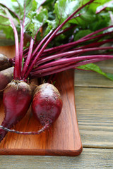 bunch of fresh beets on a cutting board