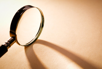 Close up Magnifying Glass on Brown Platform