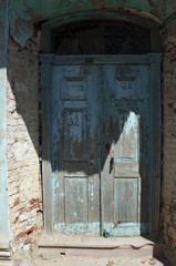 Wooden old door with stone arch
