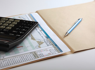Calculator, pen, folder with documents
