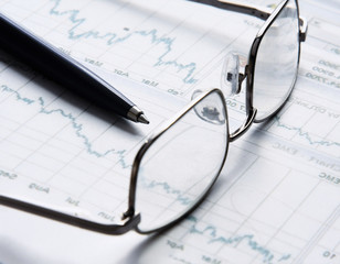 Eyeglasses lying down on a business document