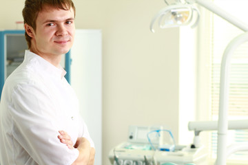 Man dentist at his office smiling