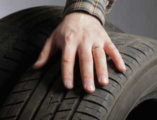 Car service. Wheels and man&amp;#39;s hand