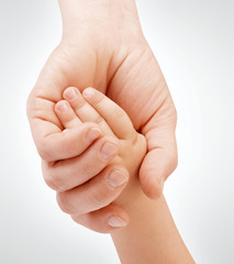 Mother holding child's hand