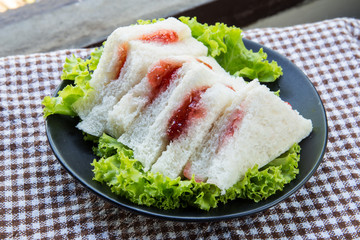 bread and strawberry marmalade on a plate