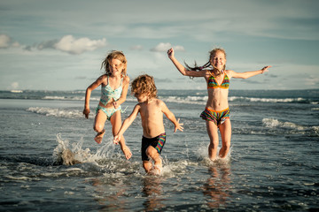 happy kids playing on beach in the day time
