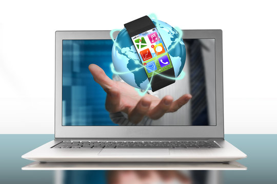 smartwatch and glowing orbit globe in palm through laptop - Powered by Adobe