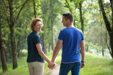 Couple walking outdoors and holding hands