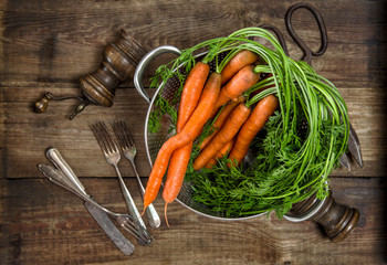 Fresh carrots on wooden background. Vegetable. Vintage style foo