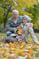 Mature couple walking in the autumn park