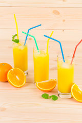 Orange juice on wooden table.