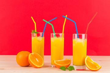 Orange juices on wooden table.