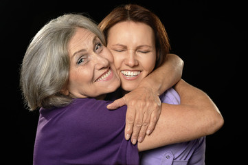 Happy mother hugging her daughter