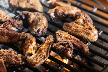 Grilling chicken wings on barbecue grill