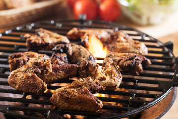 Grilling chicken wings on barbecue grill